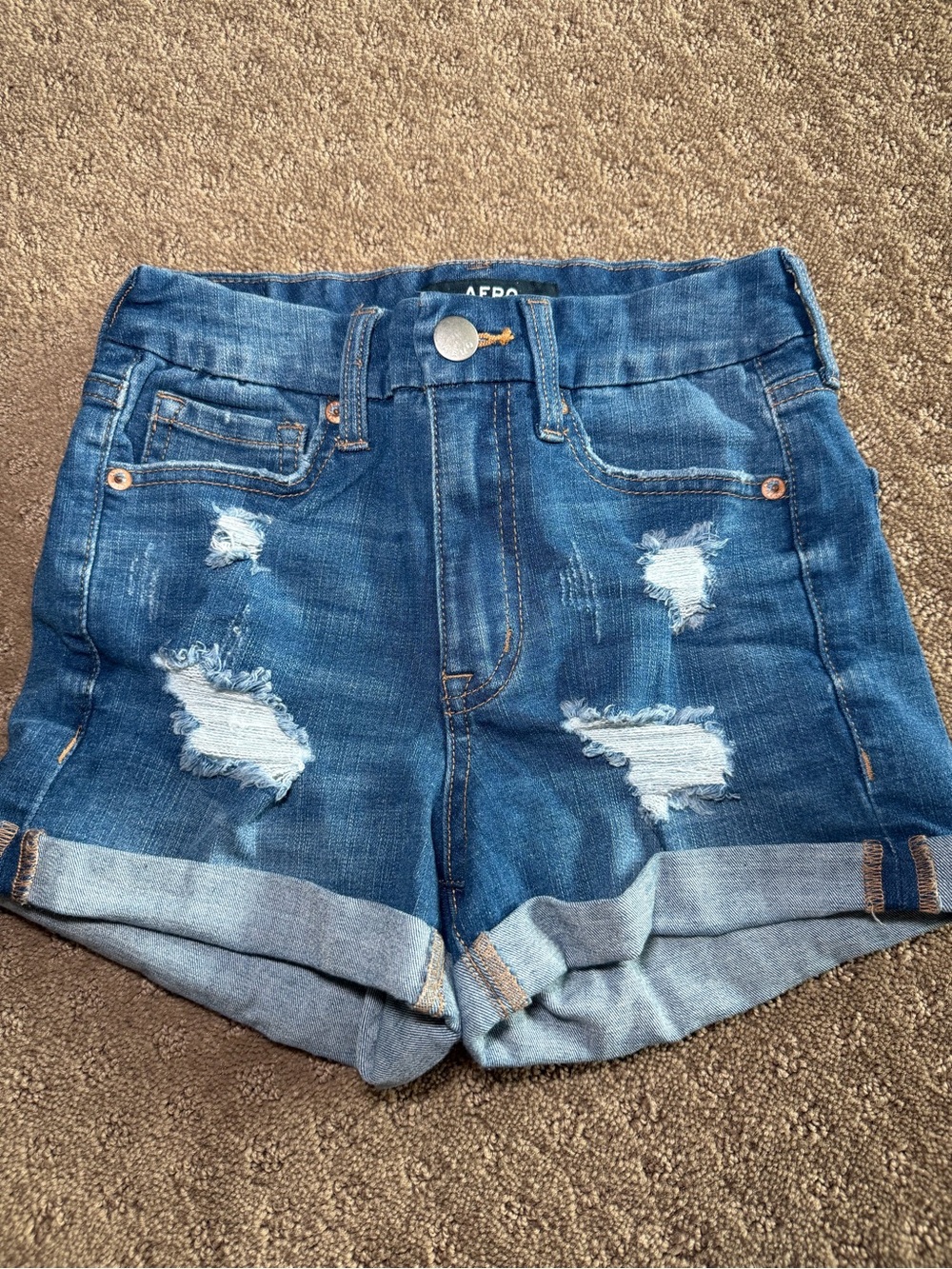 High-Rise Distressed Denim Shorts in Dark Blue